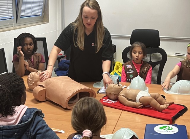 VICENZA, Italy – Vicenza Brownie Girl Scouts Troop #53 members visit the Fire Department Station on Caserma Ederle Feb. 22, 2023, as a joint experience with American Red Cross and health clinic representatives. In addition to Fire Department safety guidance, during the visit, ARC and health clinic representatives explained child and baby cardiopulmonary resuscitation (CPR) and other emergency situations.