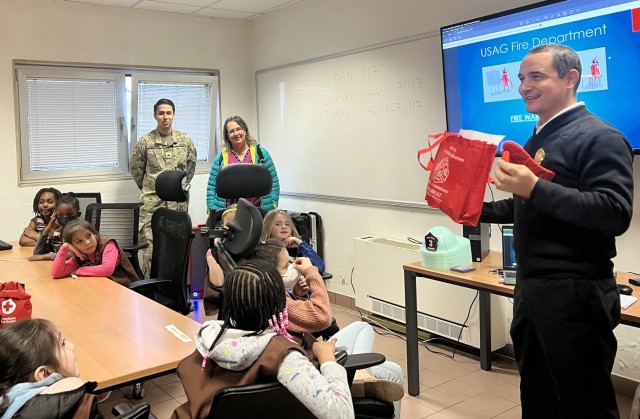 VICENZA, Italy – Luca Giaretta, battalion chief of Fire Prevention Office, Fire and Emergency Services for the garrison, talks about safety measures during the Vicenza Brownie Girl Scouts Troop #53 visit at the Fire Department Station on Caserma Ederle Feb. 22, 2023. The event, a joint experience with American Red Cross and health clinic representatives, focused on first aid tips and safety guidance in case of emergency.