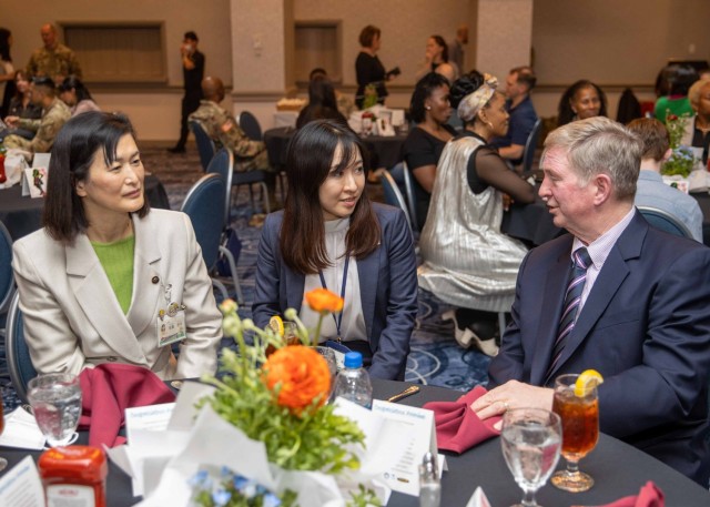 Phillip Owens, right, chief of staff of U.S. Army Japan, speaks with Zama City Mayor Mito Sato, left, during a Women's History Month luncheon at the Camp Zama Community Club, Japan, March 30, 2023. The Camp Zama community celebrated the observance with a week of various events to highlight and empower women on the installation.