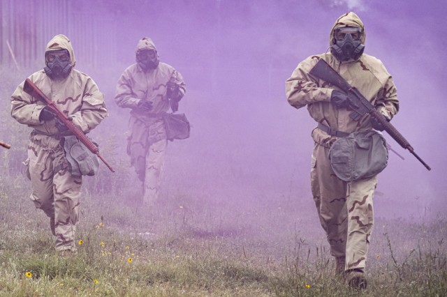 Soldiers wearing Mission Oriented Protective Posture (MOPP) gear run to a test site at Camp Bullis, Texas. They were participating in testing the Advanced Anticonvulsant System, Rafa Midazolam Auto-Injector (Rafa AI). The test was organized by U.S. Army Medical Center of Excellence Medical Test and Evaluation Activity to conduct a human factors assessment of the effectiveness of the Rafa AI and if the device meets standards set by the Joint Program Executive Office - Chemical, Biological, Radiological, Nuclear Defense.