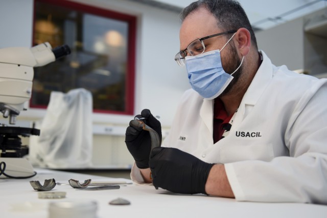 Jesse Brown, USACIL supervisory chemist, performs an explosive ordnance analysis demonstration during a laboratory visit March 28 in Forest Park, Georgia. The lab provides criminal investigators from every military branch with 24 forensic services ranging from DNA testing to latent print and trace evidence analysis.  