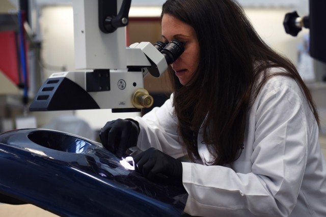 Kristin Webb, USACIL forensic chemist, performs a paint transfer demonstration during a laboratory visit March 28 in Forest Park, Georgia. The lab provides criminal investigators from every military branch with 24 forensic services ranging from DNA testing to latent print and trace evidence analysis.  