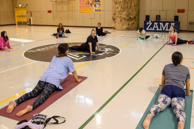 Terry Owens, center, leads a meditation and yoga session at the Camp Zama Youth Center gym as part of a Women's History Month celebration at Camp Zama, Japan, March 27, 2023. The Camp Zama community celebrated the observance with a week of various events to highlight and empower women on the installation.