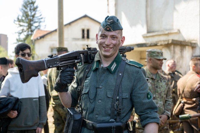 A Bulgarian volunteer carries weapon after WWII reenactment