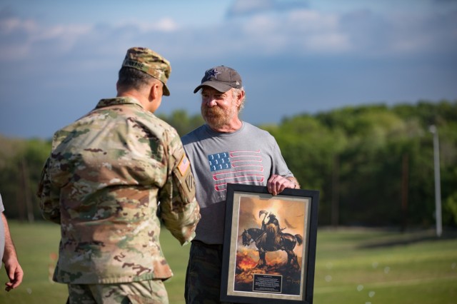 Lt. Gen. Sean Bernabe, III Armored Corps and Fort Hood commanding general, presents John Ryan of the Ryan Foundation with a special gift to commemorate the foundation's support of the Ben Hogan Classic March 31 at Fort Hood, Texas. (U.S. Army photo by Blair Dupre, Fort Hood Public Affairs)
