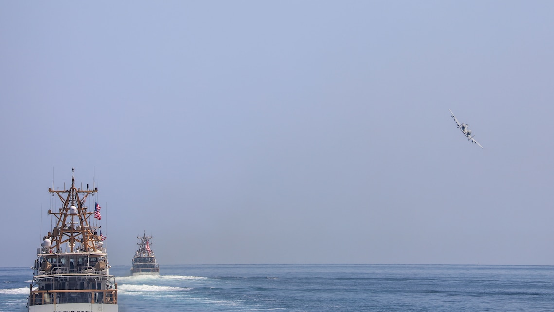 A U.S. Air Force A-10 Thunderbolt II flies above U.S. Coast Guard fast response cutters, April 28, 2023, in the Arabian Gulf during joint training.