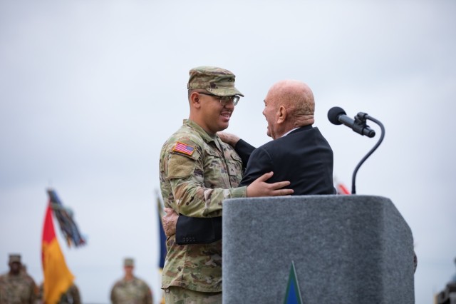 Retired Lt. Col. James M. Tucker embraces Pvt. Roman Reyes, 1st Cav. Div., during his speech at the Installation Redesignation Ceremony May 9, 2023. (U.S. Army photo by Blair Dupre, Fort Cavazos Public Affairs)