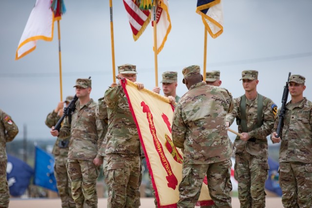 Col. Chad R. Foster and Command Sgt. Maj. Calvin Hall, command team fort Cavazos, unfurl the new Fort Cavazos flag during the Installation Redesignation Ceremony May 9, 2023, at III Armored Corps and Fort Cavazos Headquarters. (U.S. Army photo by Blair Dupre, Fort Cavazos Public Affairs)