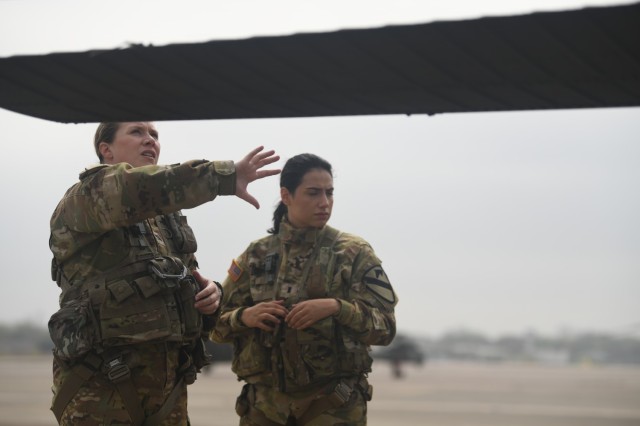 Capt. Dana Spinks, Alpha Company commander, 2-227th Aviation Regiment 1ACB goes over UH-60 Black Hawk pre-flight inspections with 1st Lt. Georgia Cervantes at Fort Cavazos, Texas.