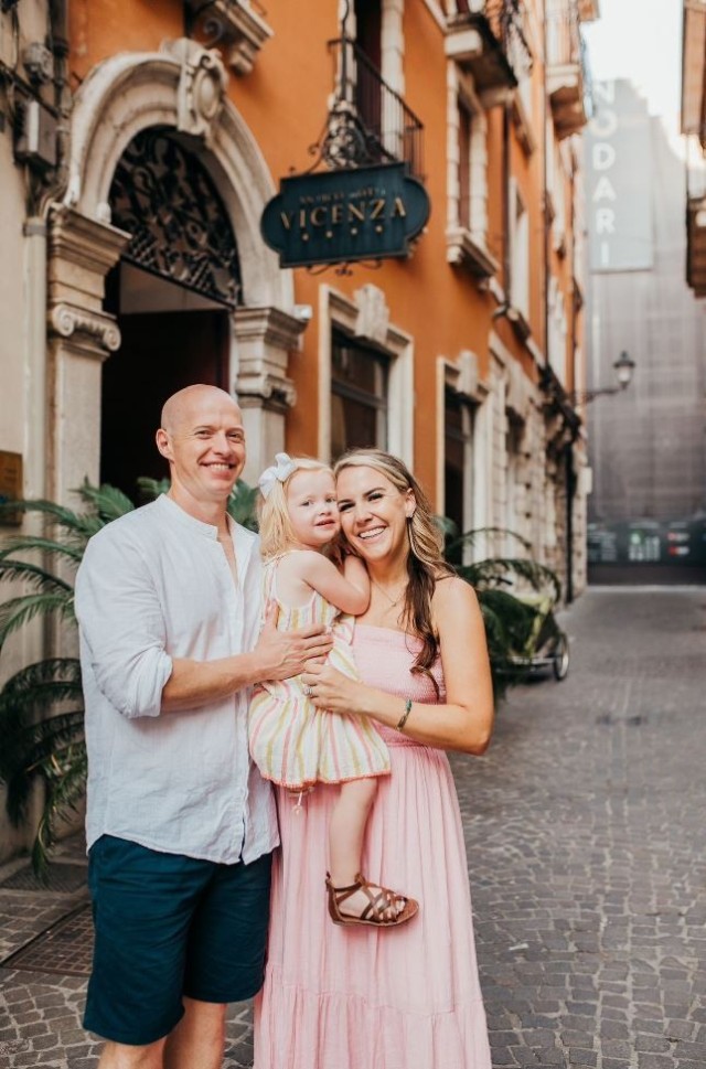 Capt. Jacob Bales and his wife, Kate, pose for a photo with their daughter, in Vicenza, Italy.