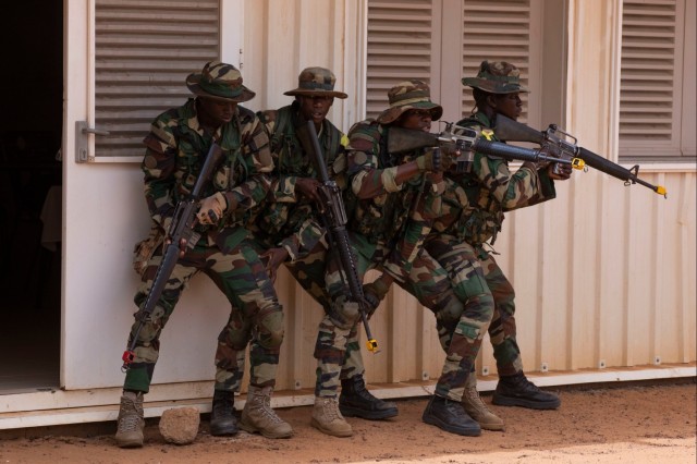 Senegalese Armed Forces soldiers move in formation to breach and clear a room during African Lion 22 in Dodji, Senegal