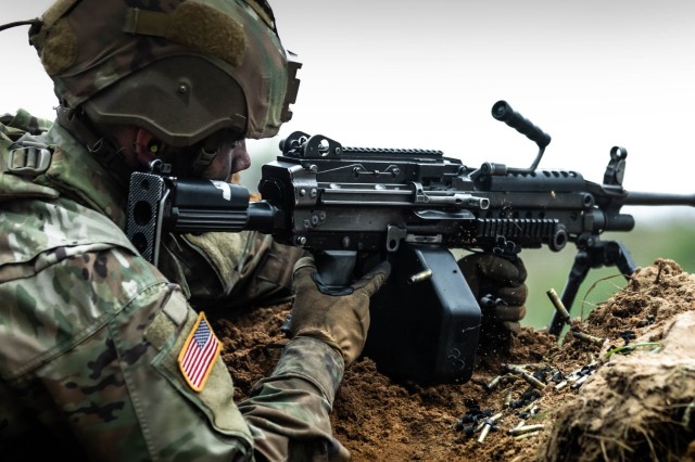 A U.S. Soldier assigned to Lightning Troop, 3rd Squadron, 2nd Cavalry Regiment, NATO Multinational Division Northeast, engages enemy targets with a 249 light machine gun during a combined arms live-fire exercise while participating in exercise Griffin Shock 23 held at Bemowo Piskie, Poland, May 16, 2023. As the framework nation in Poland, Exercise Griffin Shock demonstrates the U.S. Army's ability to assure the NATO alliance by rapidly reinforcing the NATO Battle Group Poland to a brigade-size unit. 