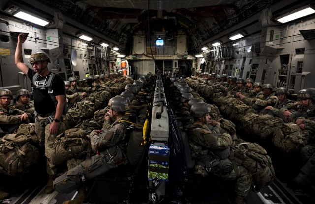 Airborne students ride in a C-130 cargo aircraft as they prepare fortheir third jump during the Basic Airborne Course at Fort Benning, Georgia, March 30. The three-week course teaches service members from every military branch how to safely conduct airborne operations. (U.S. Army photo by Staff Sgt. Dustin Biven)
