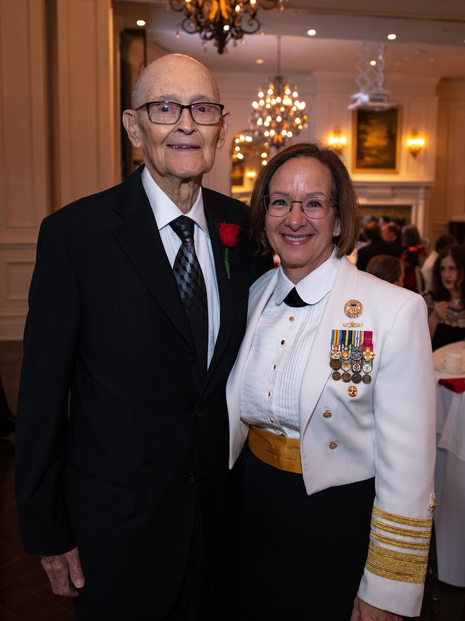 VCNO Adm. Lisa M. Franchetti presents the Presidential Unit Citation to World War II veteran Chief Petty Officer Bill Norberg.