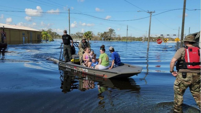 Florida National Guard Soldiers transport families through flooded roads during Hurricane Ian relief efforts in Arcadia, Fla., Oct. 3, 2022. Florida National Guard's Chemical, Biological, Radiological/Nuclear, and Explosive (CBRNE) - Enhanced Response Force Package (FL-CERFP) assisted first responders as they conducted day and night time operations in support of residents in affected regions. Maritime operations granted FLNG Soldiers the capabilities to extract individuals trapped in their homes due to compromised road conditions in order to provide medical aid and ensure safety. (U.S. Army courtesy photo by Spc. Samuel Herman)