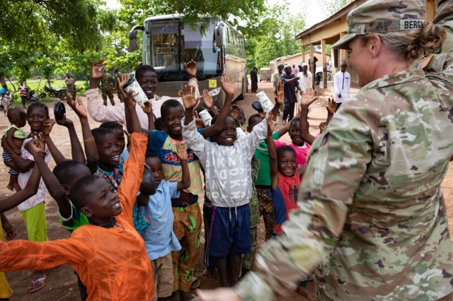 U.S. Army Lt. Col. Glenna Bergland, public health nurse, 352nd Civil Affairs Command, engages with local children during a medical event as part of exercise African Lion 2023 in Yendi, Ghana, June 3, 2023