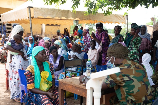 A Ghana Army soldier provides medical information to a local woman in Yendi, Ghana, June 3, 2023, during a medic civic action program as part of exercise African Lion 2023.