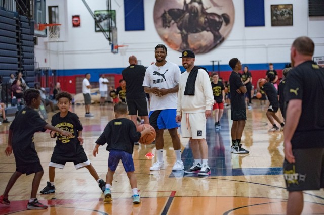 Marcus Smart watches as children participate in the five-versus-five portion of the basketball clinic June 24 at Abrams Physical Fitness Center on Fort Cavazos.  (U.S. Army photo by Blair Dupre, Fort Cavazos Public Affairs)
