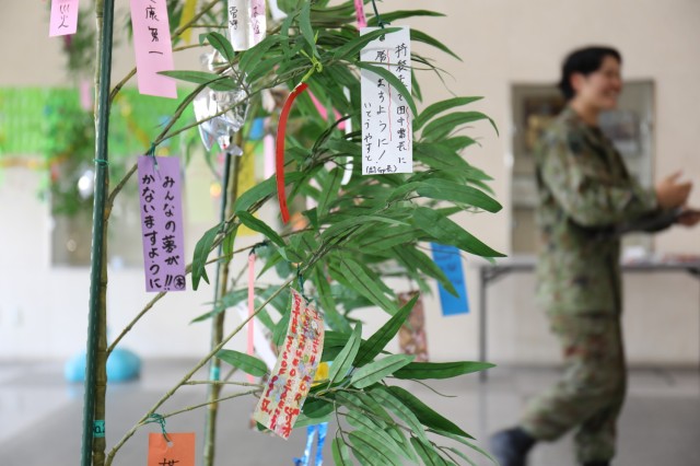 Strips of colorful paper with wishes written on them hang from small bamboo trees during an event to celebrate the "Tanabata" festival at Camp Zama, Japan, June 29, 2023. The Japan Ground Self-Defense Force's 4th Engineer Group hosted the event and invited community members to participate in the celebration. 