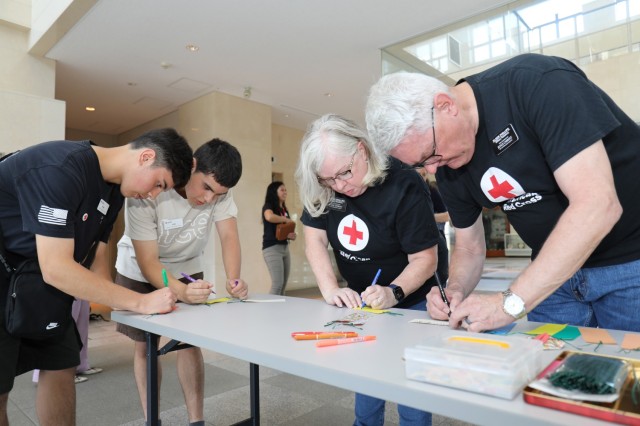Luke and Oliver Blevins, left, and Tina and Robb Phillips, all volunteers with the Camp Zama American Red Cross, participate in an event to celebrate the "Tanabata" festival at Camp Zama, Japan, June 29, 2023. The Japan Ground Self-Defense Force's 4th Engineer Group hosted the event and invited community members to join in the celebration. 