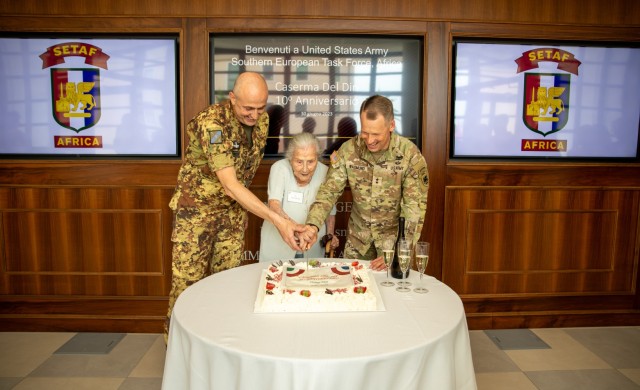 U.S. Army Maj. Gen. Todd R. Wasmund, commander of U.S. Army Southern European Task Force, Africa (SETAF-AF), right, Ms. Paola Del Din, center, and Italian army Maj. Gen. Ugo Cillo, Deputy Commander Operative Nord, cut the cake at Caserma Del Din on Jun. 30, 2023. Members of the Vicenza military community, to include U.S. Army Southern European Task Force, Africa (SETAF-AF) and the 173rd Airborne Brigade, as well as local Vicenza civilian, military and police leaders met at SETAF-AF headquarters to conduct obersvance of Caserma Del Din's 10th anniversary. SETAF-AF provides U.S. Africa Command and U.S. Army Europe & Africa a dedicated headquarters to synchronize Army activities in Africa and scalable crisis response options in Africa and Europe. (U.S. Army photo by Staff Sgt. Luke Wilson)