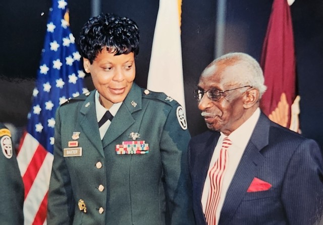 Newly promoted Brig. Gen. Sheila Baxter, stands next to  her father John Baxter Sr., of Franklin, Virginia, during her promotion ceremony June 21, 2003 at the Women in Military Service to America Memorial in Arlington. Baxter was the first female general officer in the Medical Service Corps. 