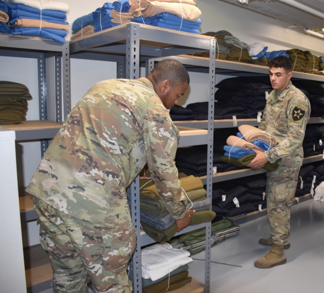 Pvt. Joshua Cotton, 3rd Cavalry Regiment, and Pfc. Michael Clark, 15th Military Intelligence Battalion, help organize linen Thursday at the Installation Reception Center. Both Soldiers arrived the night before. (U.S. Army photo by Janecze Wright, Fort Cavazos Public Affairs)