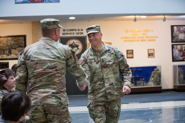 Lt. Gen. Sean C. Bernabe, III Armored Corps and Fort Cavazos commanding general, shakes hands with Col. Chad R. Foster, outgoing Fort Cavazos Garrison commander, during the Fort Cavazos Garrison Change of Command Ceremony July 7 at III Armored Corps and Fort Cavazos Headquarters. (U.S. Army photo by Blair Dupre, Fort Cavazos Public Affairs)