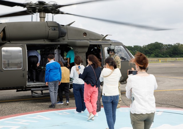 A group of master labor contractors assigned to U.S. Army Medical Department Activity-Japan board a UH-60 Black Hawk helicopter as part of an employee appreciation day at Camp Zama, Japan, July 20, 2023. The event included an area orientation flight over nearby U.S. military health facilities and a pot luck lunch for the employees at the BG Sams U.S. Army Health Clinic. 