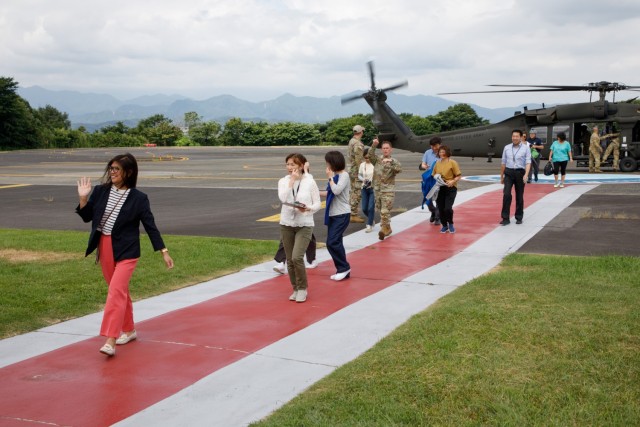 A group of master labor contractors assigned to U.S. Army Medical Department Activity-Japan complete a flight aboard a UH-60 Black Hawk helicopter as part of an employee appreciation day at Camp Zama, Japan, July 20, 2023. The event included an area orientation flight over nearby U.S. military health facilities and a pot luck lunch for the employees at the BG Sams U.S. Army Health Clinic. 