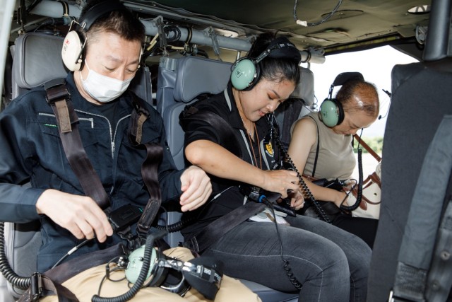A group of master labor contractors assigned to U.S. Army Medical Department Activity-Japan prepare to fly in a UH-60 Black Hawk helicopter as part of an employee appreciation day at Camp Zama, Japan, July 20, 2023. The event included an area orientation flight over nearby U.S. military health facilities and a pot luck lunch for the employees at the BG Sams U.S. Army Health Clinic. 