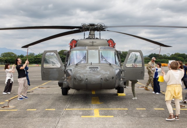 A group of master labor contractors assigned to U.S. Army Medical Department Activity-Japan get a close-up look at a UH-60 Black Hawk helicopter during an employee appreciation day at Camp Zama, Japan, July 20, 2023. The event included an area orientation flight over nearby U.S. military health facilities and a pot luck lunch for the employees at the BG Sams U.S. Army Health Clinic.