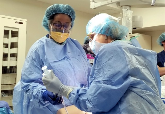 WATERTOWN, N.Y. – Capt. Heather Irobunda (left), an obstetrics physician with the U.S. Army Medical Department Activity, Fort Drum, N.Y., works with a labor and delivery nurse from the Samaritan Medical Center to control the bleeding of a simulated patient during an emergency preparedness training scenario in Watertown, N.Y. June 7.  Obstetrics and gynecology health care professionals from Fort Drum work side by side with their civilian counterparts at Samaritan to provide pregnancy, labor and delivery care to Fort Drum service members and their families.