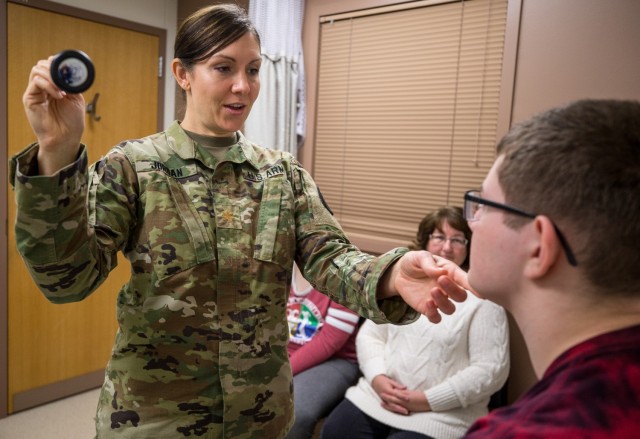 Maj. Bonnie Jordan, a physician assigned to Madigan Army Medical Center at Joint Base Lewis-McChord, Washington, examines her patient, Arthur Wasson, on Nov. 28. Jordan was recently awarded the Military Health System's Female Physician Leadership Award for her dedication and work to sick and injured Soldiers of the Fort Carson Warrior Transition Battalion. Jordan renovated several processes WTB Soldiers participate in to help them heal or transition to civilian life, as well as her guidance to their family members and her dedication to mentoring fellow physicians.  