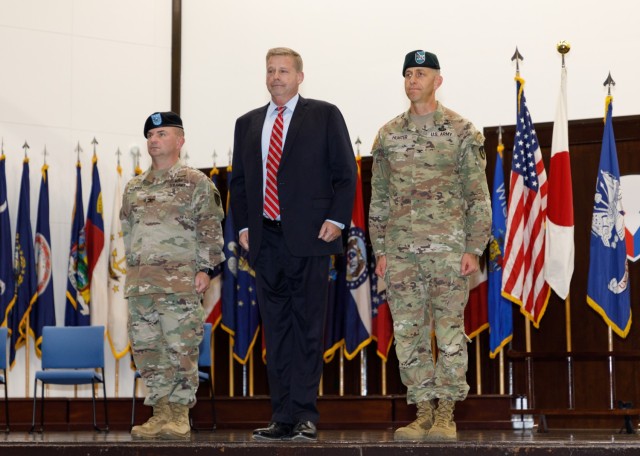 Col. Christopher L. Tomlinson, left, relinquishes command of U.S. Army Garrison Japan to Col. Marcus S. Hunter, right, during a change-of-command ceremony at Camp Zama, Japan, July 7, 2023. Craig Deatrick, director of U.S. Army Installation Management Command-Pacific, presided over the ceremony held at Kizuna Hall.