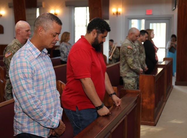 Attendees bow their heads in prayer during a ceremony celebrating the Camp Zama Chapel's 70 years of service and the U.S. Army Chaplain Corps' 248-year anniversary at the chapel July 28, 2023. Built in 1953, the chapel was modeled after the Nasugbu Beach Chapel in Yokohama.