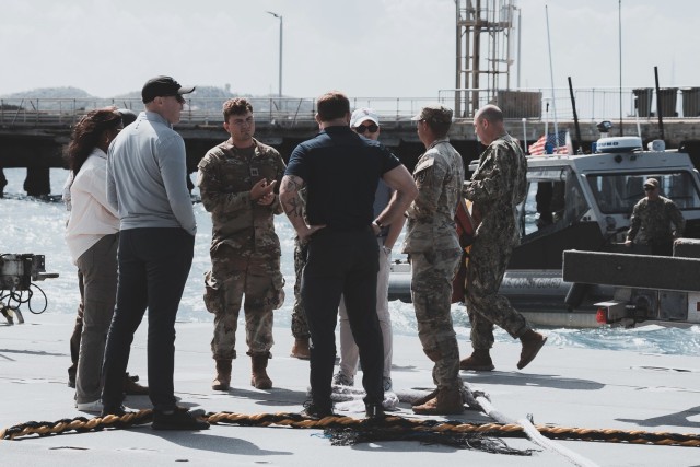 The host of professional staff members representing different congressional districts stand aboard the roll on/roll off discharge facility as they prepare to board a coast guard vessel in Bowen, Australia, July 29, 2023. The staff delegation was in Australia to observe Joint Logistics Over-the-Shore, one of the many critical sustainment capabilities rehearsed during Talisman Sabre 2023. 