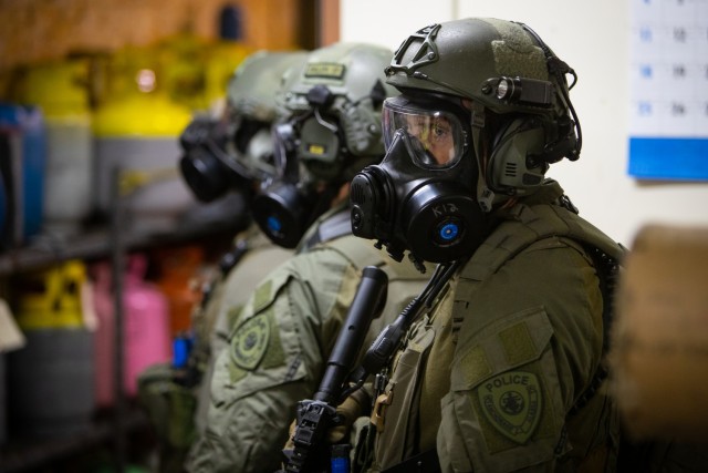 Members of the Anchorage Police Department SWAT unit work through an active shooter/hostage scenario on the UAA campus June 13, 2023. The active shooter portion is part of ORCA 2023, a biennial exercise designed to maintain readiness, validate response procedures, and collaborate with first response agencies across the state. The exercise, hosted by the Alaska National Guard’s 103rd Weapons of Mass Destruction - Civil Support Team, included 12 National Guard units from Alaska, Washington, Nebraska, Mississippi, Kansas, Ohio, Hawaii, and Kentucky, eight local and state entities, three federal agencies, and various community partners.