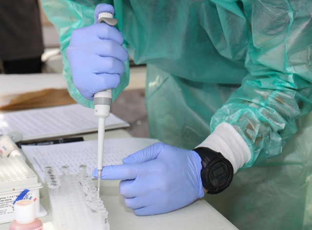 Akira Iwami, a molecular biologist at Public Health Command–Pacific in Japan, demonstrates how to perform pathogen analysis using a field lab as part of a knowledge-sharing event at Camp Zama, Japan, Aug. 21, 2023.