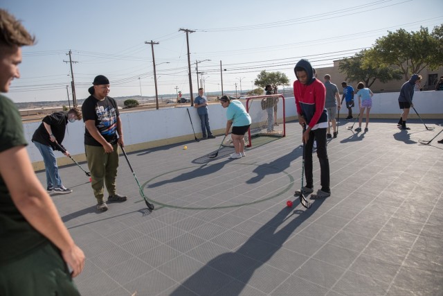 Children participate in a passing drill at the beginning of the Boeing-Dallas Stars Hockey Clinic. (U.S. Army photo by Blair Dupre, Fort Cavazos Public Affairs)