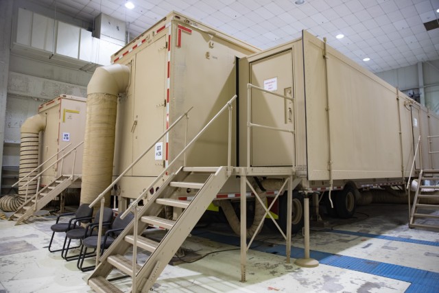 The new AH-64 Guardian flight simulator sits next to the other Apache simulator at the Fort Cavazos Flight Simulation Division. The new simulator has modernized features.