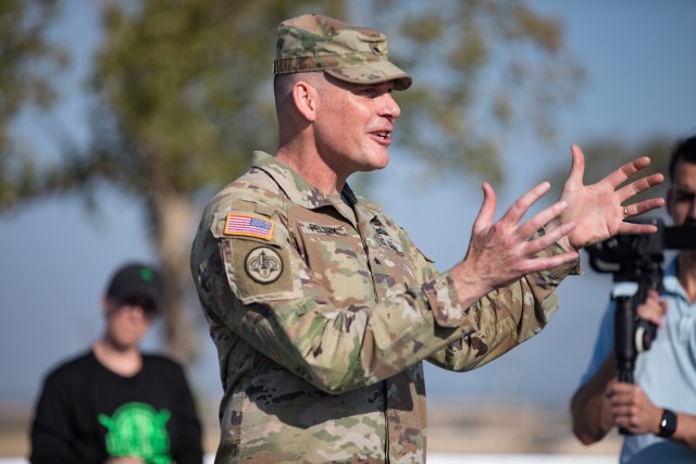 Brig. Gen. Thomas M. Felty, III Armored Corps deputy commanding general of maneuver, makes remarks before the hockey clinic Aug. 10 at the ball hockey court. (U.S. Army photo by Blair Dupre, Fort Cavazos Public Affairs)