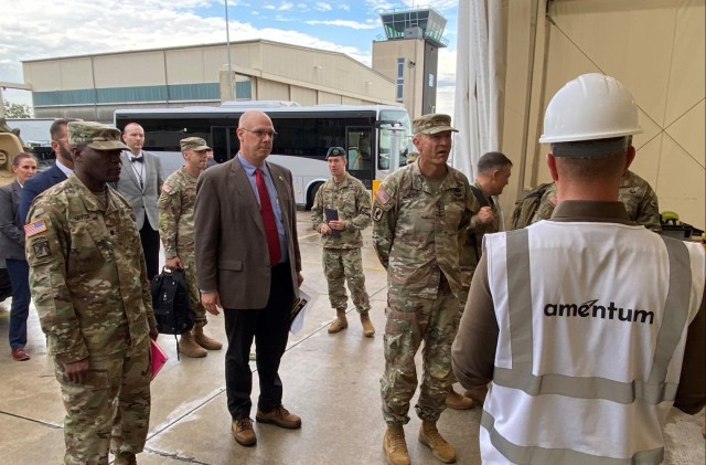 Army Lt. Col. Omar McKen, the Army Field Support Battalion-Mannheim commander (left), provided Vice Chief of Staff of the Army Gen. Randy George and other senior leaders present a tour of a couple of his facilities at Coleman Army Prepositioned Stocks-2 worksite in Mannheim, Germany, June 25. Mission partners of the 405th Army Field Support Brigade tasked with the day-to-day storage and maintenance of thousands of tactical vehicles and combat equipment pieces at the site — to include an entire modernized armored brigade combat team — also assisted with showing the visitors the facilities.