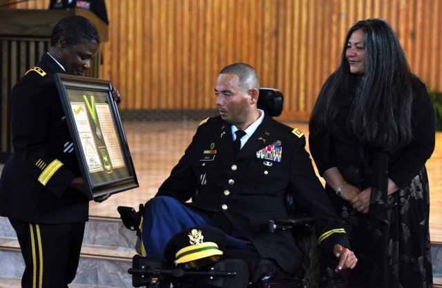 Lt. Gen. Donna Martin, Army inspector general, awards Capt. Luis Avila the Order of the Marechausse, silver, during a ceremony at the Memorial Chapel on Joint Base Myer-Henderson Hall, Virginia, Aug. 23. In 2011, Avila was leading a search and rescue mission in Afghanistan when a 600-pound improvised explosive device detonated underneath his vehicle killing three of his Soldiers and leaving him severely wounded.  