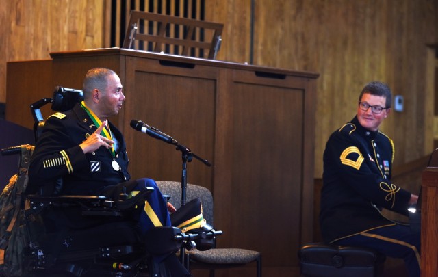 Capt. Luis Avila sings "God Bless America" during his Order of the Marechausse award ceremony at Joint Base Myer-Henderson Hall, Virginia, Aug. 23. He was awarded the Military Police Regimental Association's Order of the Marechausse, silver, for his professionalism, high standards of integrity and morality, and esprit de corps. 