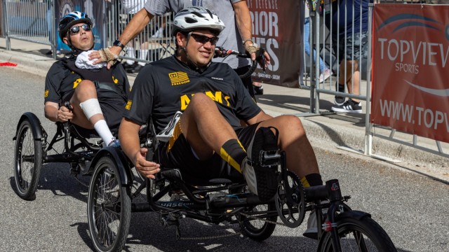 U.S. Army Capt. Luis Avila and his son Miguel Avila approach the starting line at the ESPN Wide World of Sports Complex, Orlando, Florida during the 2022 Department of Defense Warrior Games, Aug. 22, 2022. Hosted by the U.S. Army at the Walt Disney World Resort, this year’s Warrior Games sees service members and veterans from across the DoD competing in a variety of adaptive sports alongside armed forces athletes from Canada and Ukraine.