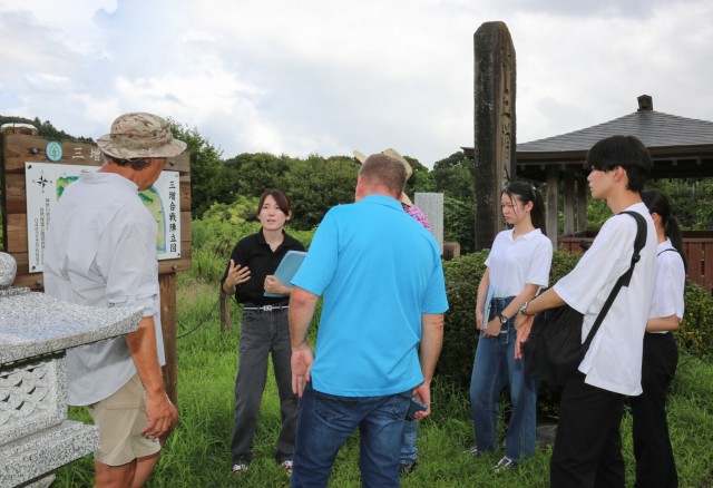 Yukiko Muroi, second from left, speaks about the Battle of Mimasetoge during a site survey in Aikawa, Japan, Aug. 23, 2023. Muroi and another intern, Anon Anami, developed self-guided tours as part of their capstone projects for U.S. Army Garrison Japan's summer internship program.