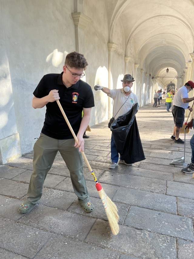 VICENZA, Italy – Volunteers of the Alpini groups of Vicenza, the Order of Malta alongside the American Soldiers and their family members clean the leaves from the porticoes, and also armed with brooms, mops and poles remove cobwebs from arches and columns during the cleanup of the arcades and the area leading up to the Basilica of Monte Berico Aug. 26, 2023. The annual event is part of an ongoing partnership to prepare the site for the upcoming festivities of the patron saint “Virgin Mary of Monte Berico” and the arrival of thousands of pilgrims from all over the region on Sept. 8.