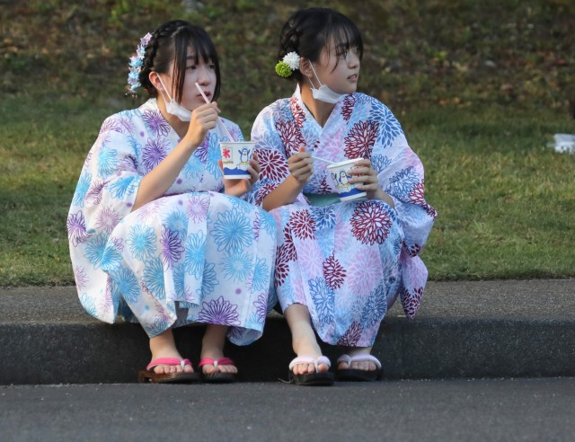 A pair of Japanese girls dressed in yukatas attend the Bon Odori festival at Camp Zama, Japan, Aug. 5, 2023. About 20,000 people attended this year's event, which honors the departed spirits of one’s ancestors. The traditional Japanese festival has been celebrated at Camp Zama since 1959.