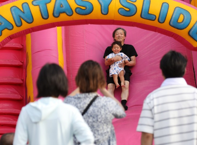 Japanese guests enjoy a children's attraction during the Bon Odori festival at Camp Zama, Japan, Aug. 5, 2023. About 20,000 people attended this year's event, which honors the departed spirits of one’s ancestors. The traditional Japanese festival has been celebrated at Camp Zama since 1959.